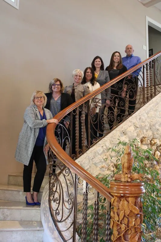 Ann with retreat guests on the estate staircase
