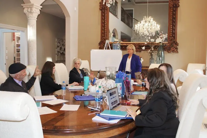 Business owners in a strategy session around the estate dining table